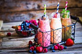 Three smoothies and fresh berries