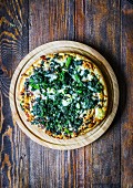 Pizza with spinach, mozzarella and goat's cheese (seen from above)