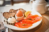 A healthy breakfast with smoked salmon and a soft boiled egg