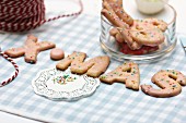 Letter-shaped biscuits decorated with sugar sprinkles spelling XMAS