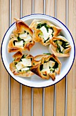 Filo pastry packets filled with feta cheese and spinach (Greece)