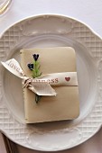 Small book tied with ribbon as table decoration for wedding
