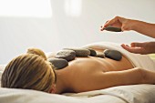 A woman having a hot stone massage