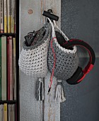 Crocheted storage baskets hanging on a cupboard door