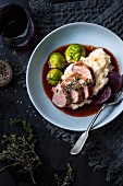 Pork fillet with a red wine vinegar sauce served with Brussels sprouts and mashed potatoes