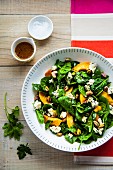 Spinach salad with poached quinces, blue cheese and pistachios