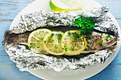 Trout with lemon and herbs in aluminium foil