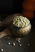 Dried green peas in a metal bowl