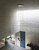 Impressive chandelier with geometric silhouette in architect-designed concrete house