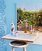 Picture of garden on top of fold-down table with wooden stool