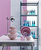 Iconic stainless steel shelves, chrome dining table and pink, fifties-style kitchen accessories