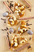 Cashew brittle with spices on a wooden surface