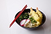 Nabe (Japanese stew) with udon noodles with prawn tempura