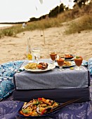 A beach picnic with a pasta salad, cold tomato soup and canapés
