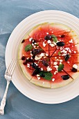 A watermelon salad with black olives and peppermint