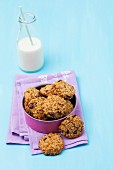 Oat cookies in a tin with milk