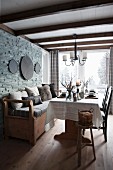 Rustic dining area with bench against stone wall