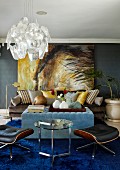 Dramatic painting on dark grey wall in living room with pale blue ottoman and classic designer furnishings