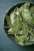 Dried bay leaves in a ceramic bowl