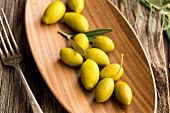 Fresh olives on a wooden dish
