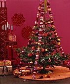 Christmas tree with red decorations and garlands of carnations