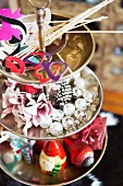 Various decorations and Christmas baubles on silver cake stand