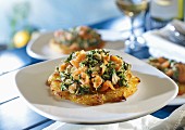 A potato fritter topped with salmon and spinach