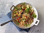 Stir-fried noodles with beef, peppers and coriander