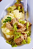 Pork goulash with pointed cabbage on a bed of mashed potatoes