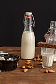 Homemade almond milk in a flip-top bottle and a glass