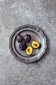 Fresh plums on a metal plate