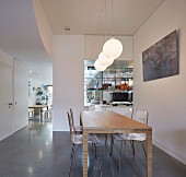 Modern dining area with view into kitchen