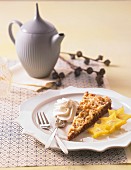 Spiced cake with marzipan crumbles, cream and star fruits