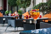 A citrus fruit cocktail on a patio table (Buddha-Bar Hotel, Paris)