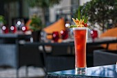 A red fruit cocktail on a patio table (Buddha-Bar Hotel, Paris)