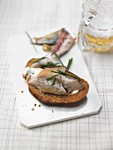 Smoked fish on grilled bread with chives