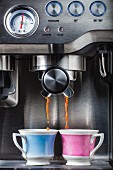 An espresso machine and two cups