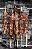Lamb skewers on a barbecue (seen from above)