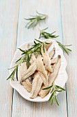 Anchovy fillets in oil with fresh rosemary