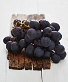 Freshly washed red grapes on a wooden board
