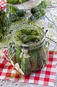Gherkins with garlic and dill in a preserving jar