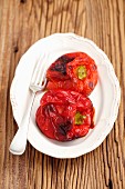 Roasted red peppers on a plate with a fork