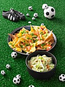 Gratinated nachos with guacamole for a football themed party