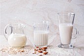 Oat milk, almond milk and rice milk on a marble surface