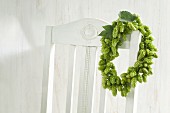 Wreath of hops hanging on chair backrest