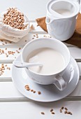 Spelt milk in a white cup