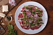 Beef carpaccio with radishes and rocket