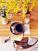 View of laid table with wooden board, menu card and yellow flowers