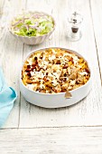 Farfalle bake with chicken, mushrooms, dried tomatoes, cream and feta cheese