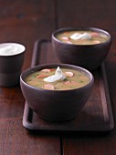 Potato soup with sliced sausages and sour cream